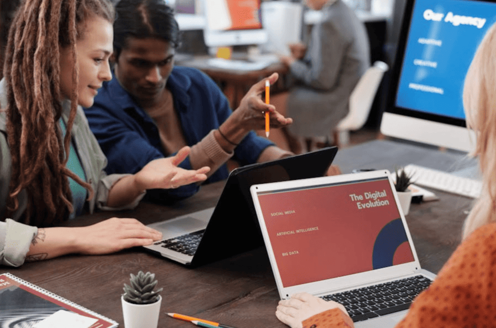 People looking at their computer and talking