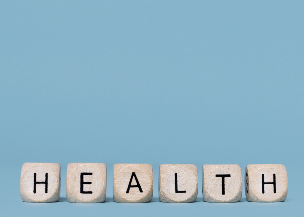 wooden block spelling "health" on blue background