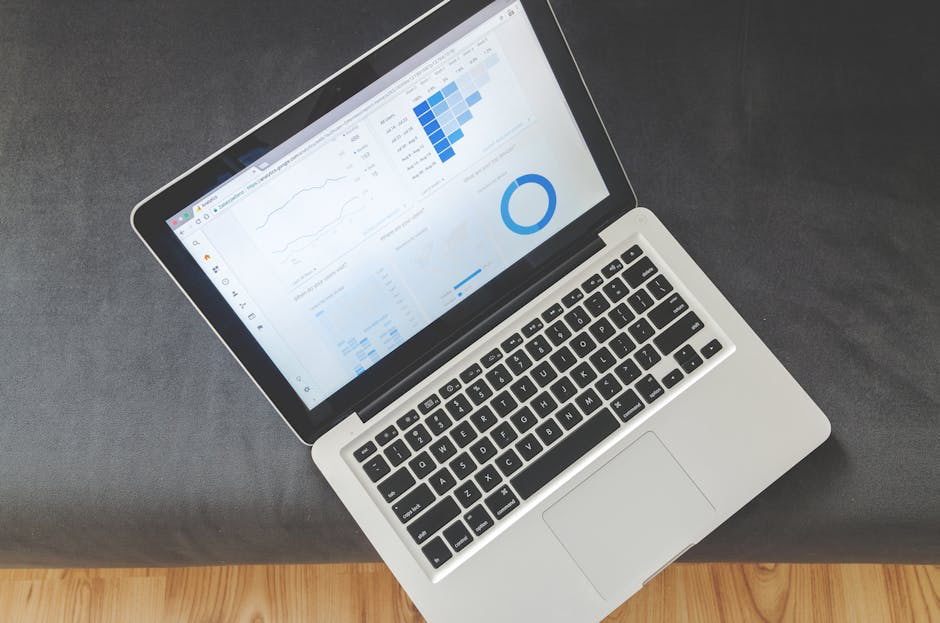 Open laptop displaying analytics charts and graphs.