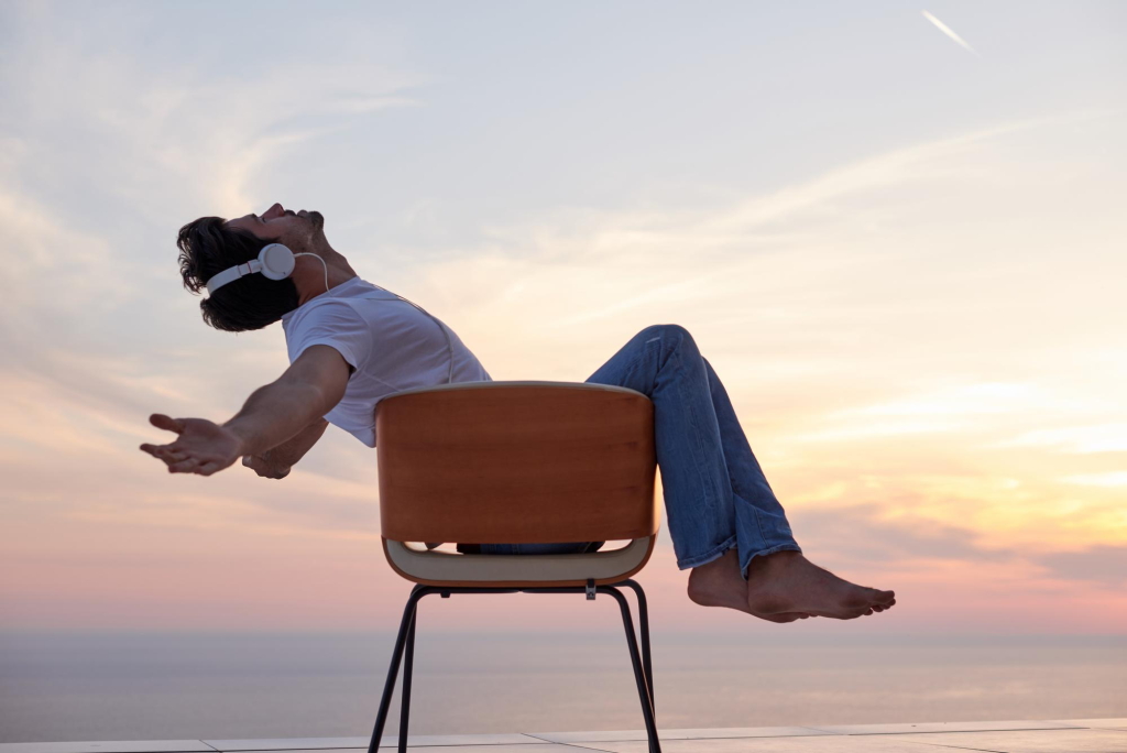 sitting on a chair listening to music