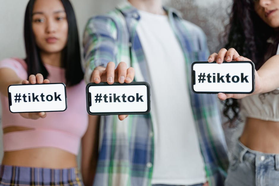 A thriving online brand community on a platform like Reddit or TikTok - Drive brand awareness Three people holding TikTok signs.