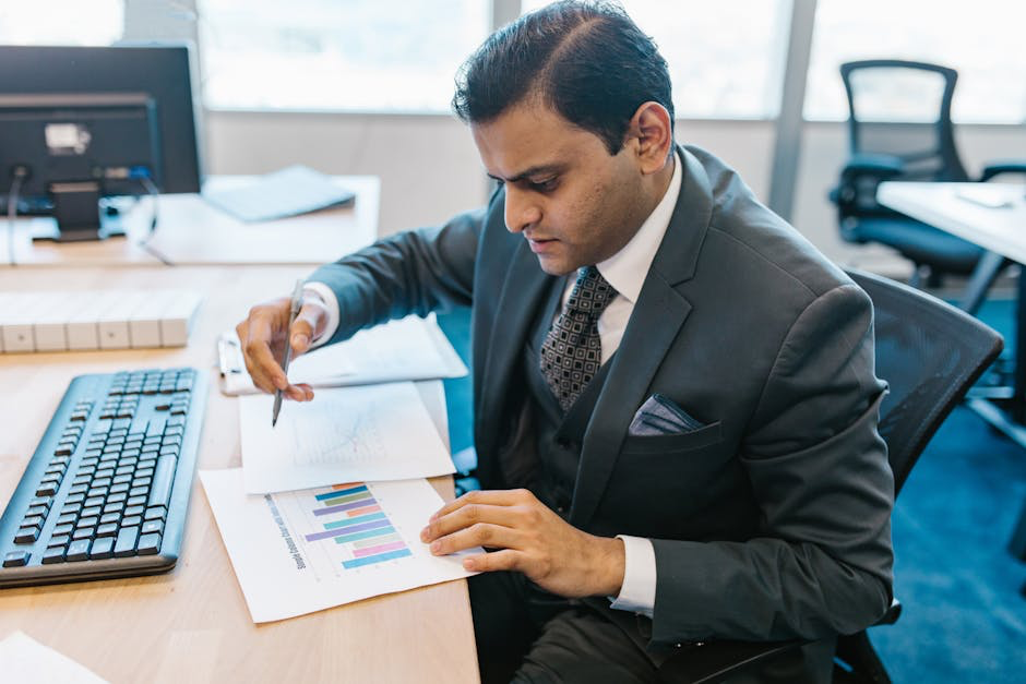person analyzing charts and strategy - Social media audits Businessman analyzing graphs at desk.