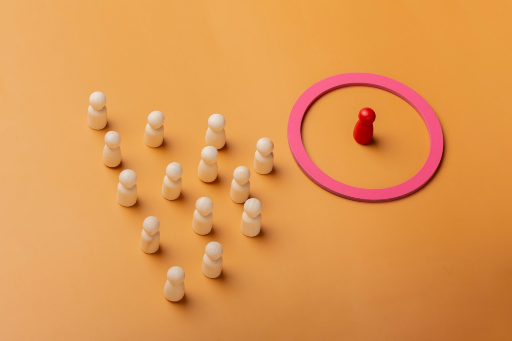 Red figure inside pink circle, wooden figures