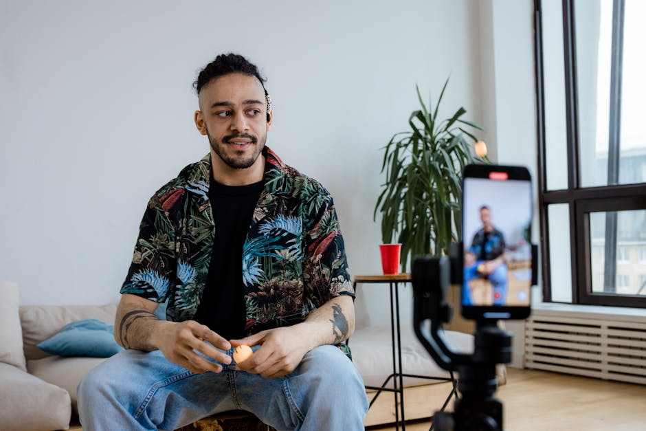 image of a person creating compelling video content - Attract target audience Man sitting with phone recording video.