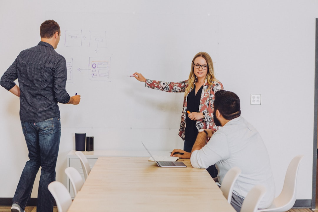 people with a wood table and white board