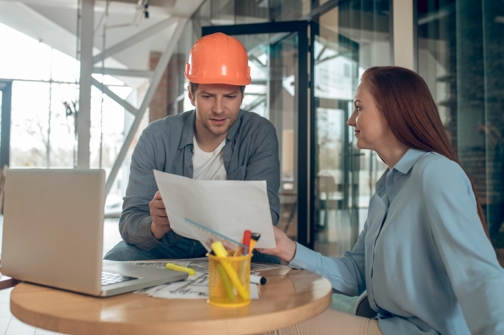 two persons talking with construction